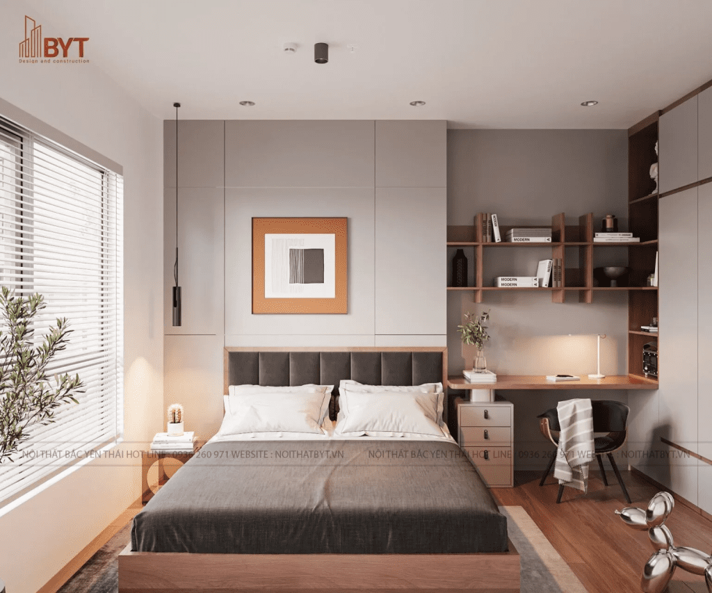 Không gian nghỉ ngơi trong căn hộ 30m2 với giường đôi và bàn làm việc mini, kết hợp giá sách treo tiện dụng