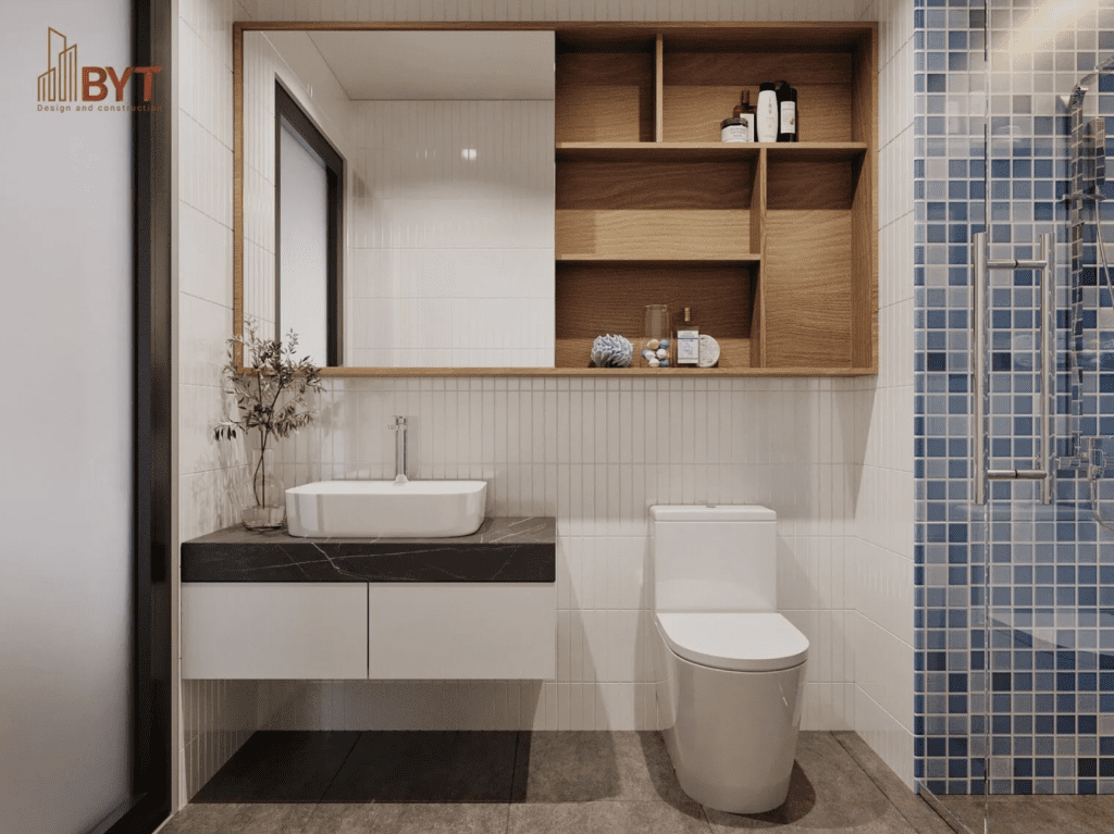 Phòng tắm căn hộ 30m2 thiết kế tối giản với thiết bị treo tường, gương lớn và vách kính hiện đại