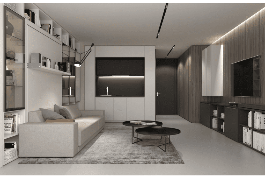 Thiết kế nội thất căn hộ 30m2 sử dụng tông màu trung tính hiện đại, bố trí không gian mở kết hợp phòng khách và bếp, tận dụng kệ tường để tăng diện tích lưu trữ
